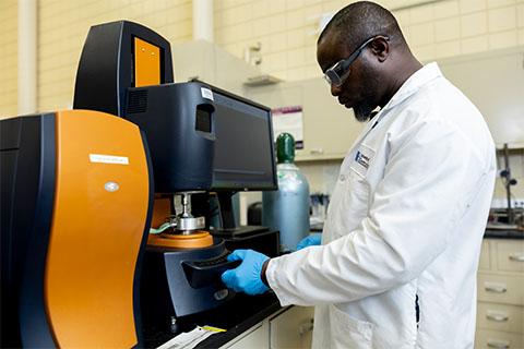 dr. akinbode adedeji using a tool in the fool lab